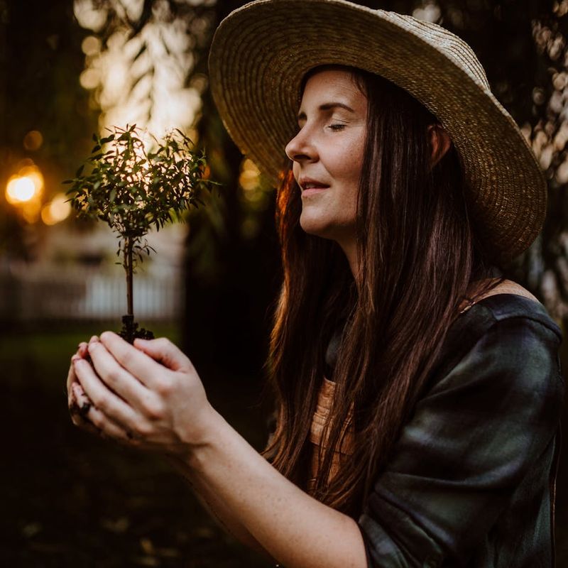 Woman meditating peacefully in a serene environment with soft lighting.